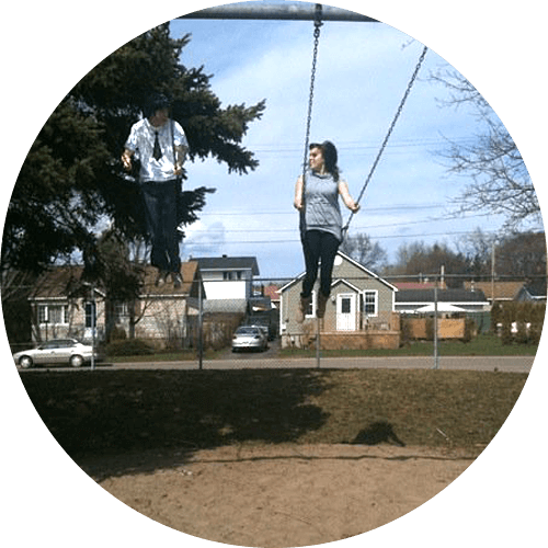 Eric and Nilah on a swingset